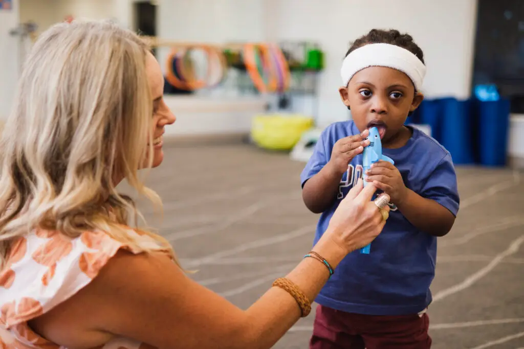 clinician using vibration tools in feeding therapy to increase oral awareness
